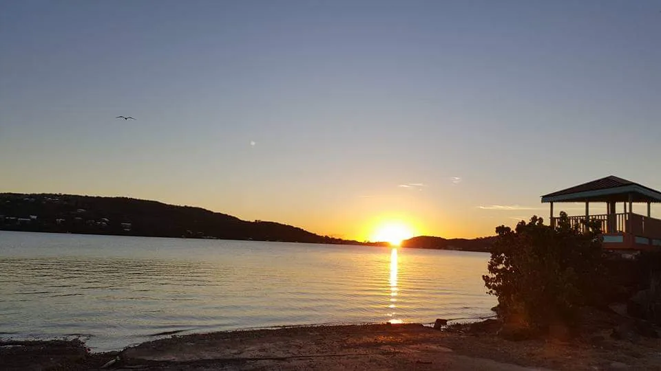 Sunset over Culebra's harbor with a waterfront gazebo silhouetted on the shore