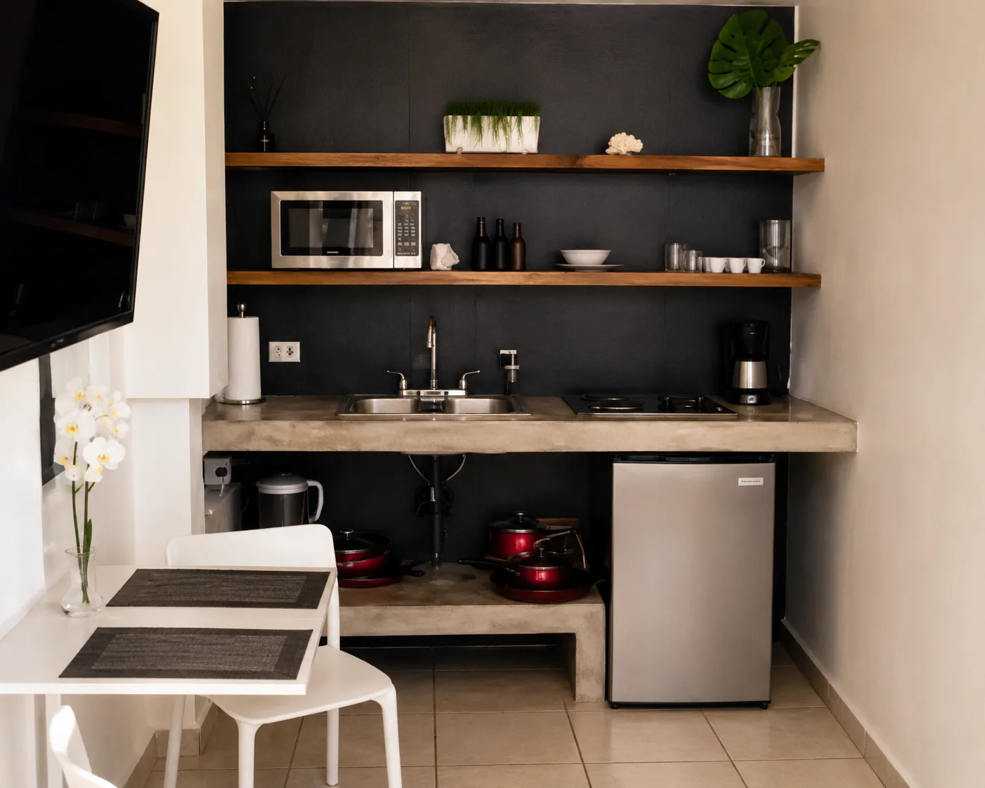 Gibraltar kitchenette with concrete counter and dining table