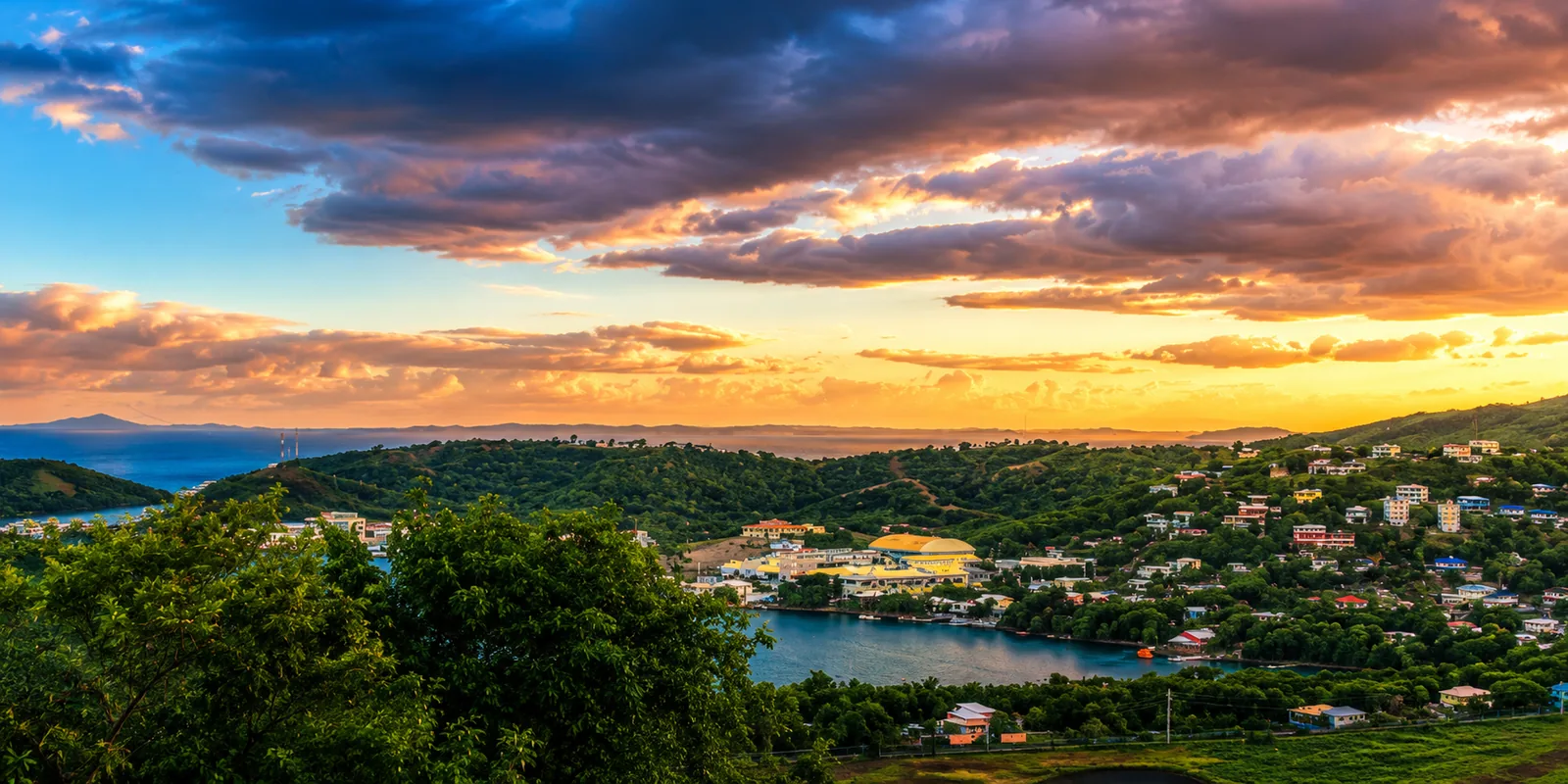 Sunset panorama over Culebra town, green hills, and the bay, photographed from Casa Carmen