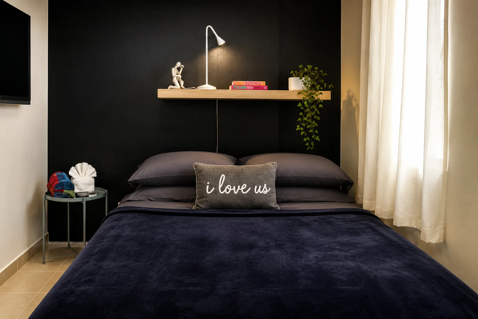 Gibraltar bedroom with a dark accent wall and queen bed